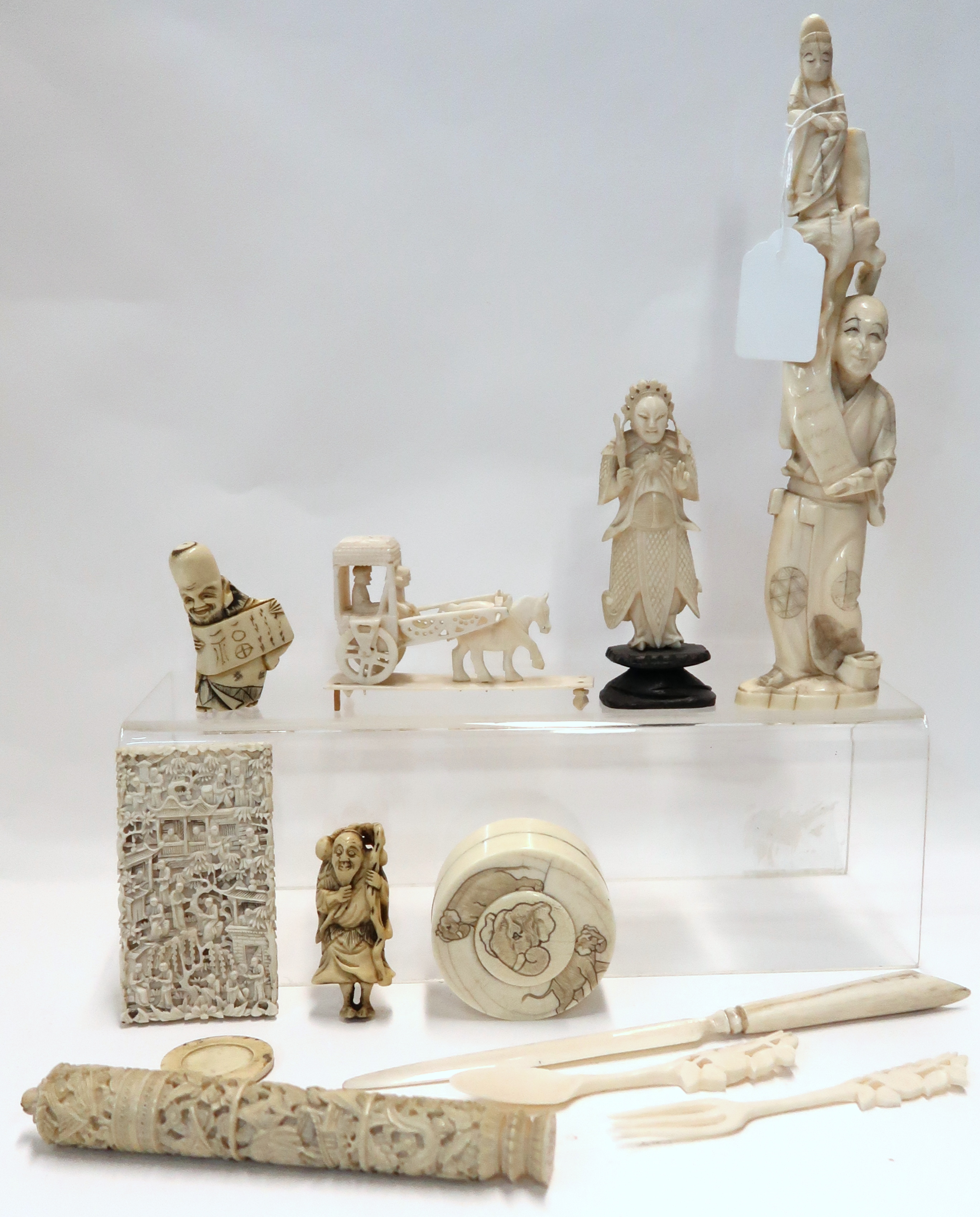 A collection of carved ivory and bone items including an okimono, a card case, needle case etc