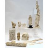 A collection of carved ivory and bone items including an okimono, a card case, needle case etc