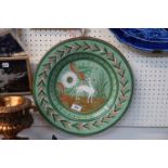 A Persian terracotta plate painted with a deer and foliage Condition Report: Available upon request