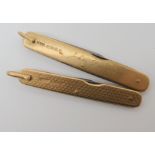 A pair of 9ct gold cased penknives weight together 53.4gms Condition Report: Available upon request