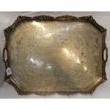 A large silver plated serving tray with pierced gallery and integral twin handles, bearing an