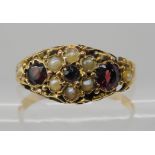 A 15ct gold garnet and pearl ring hallmarked Chester 1882, size T, weight 2gms Condition Report: