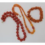 A string of amber beads, cherry amber coloured beads and an amber chip bracelet Condition Report: