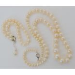 A string of white cultured pearls with a silver clasp, largest pearl 9.7mm, tapering to smallest 4.