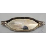A silver dish, London 1809, of shallow boat shape inscribed "Presented to Captain J. H. Goodall by