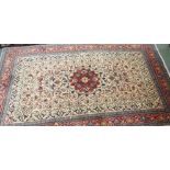 A cream ground Keshan rug with red central medallion and border, 208cm x 132cm Condition Report: