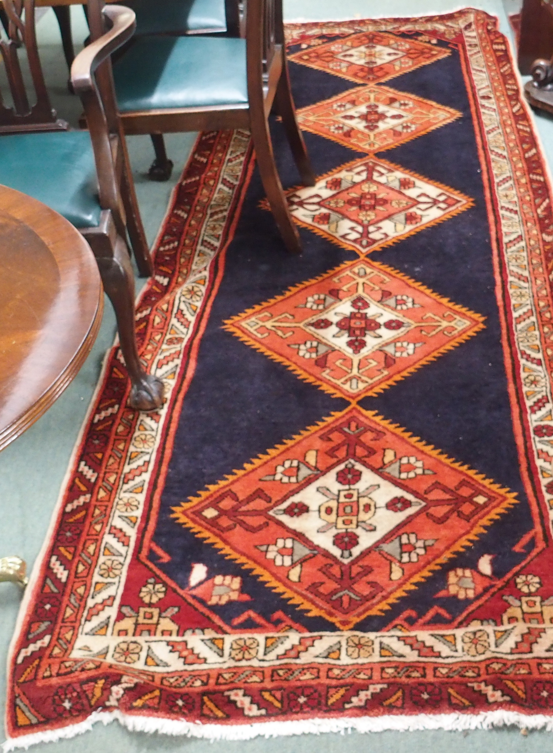 A blue ground Karajeh runner with five central lozenges, 310cm x 118cm Condition Report: Available
