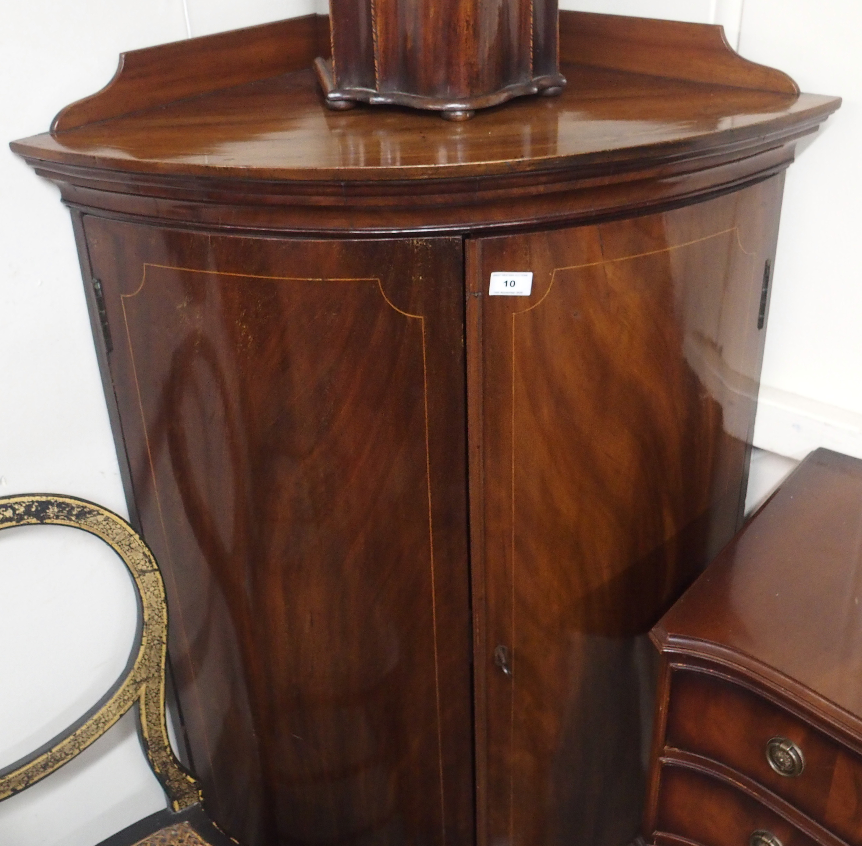 A mahogany bow front corner cabinet, 124cm high x 80cm wide Condition Report: Available upon