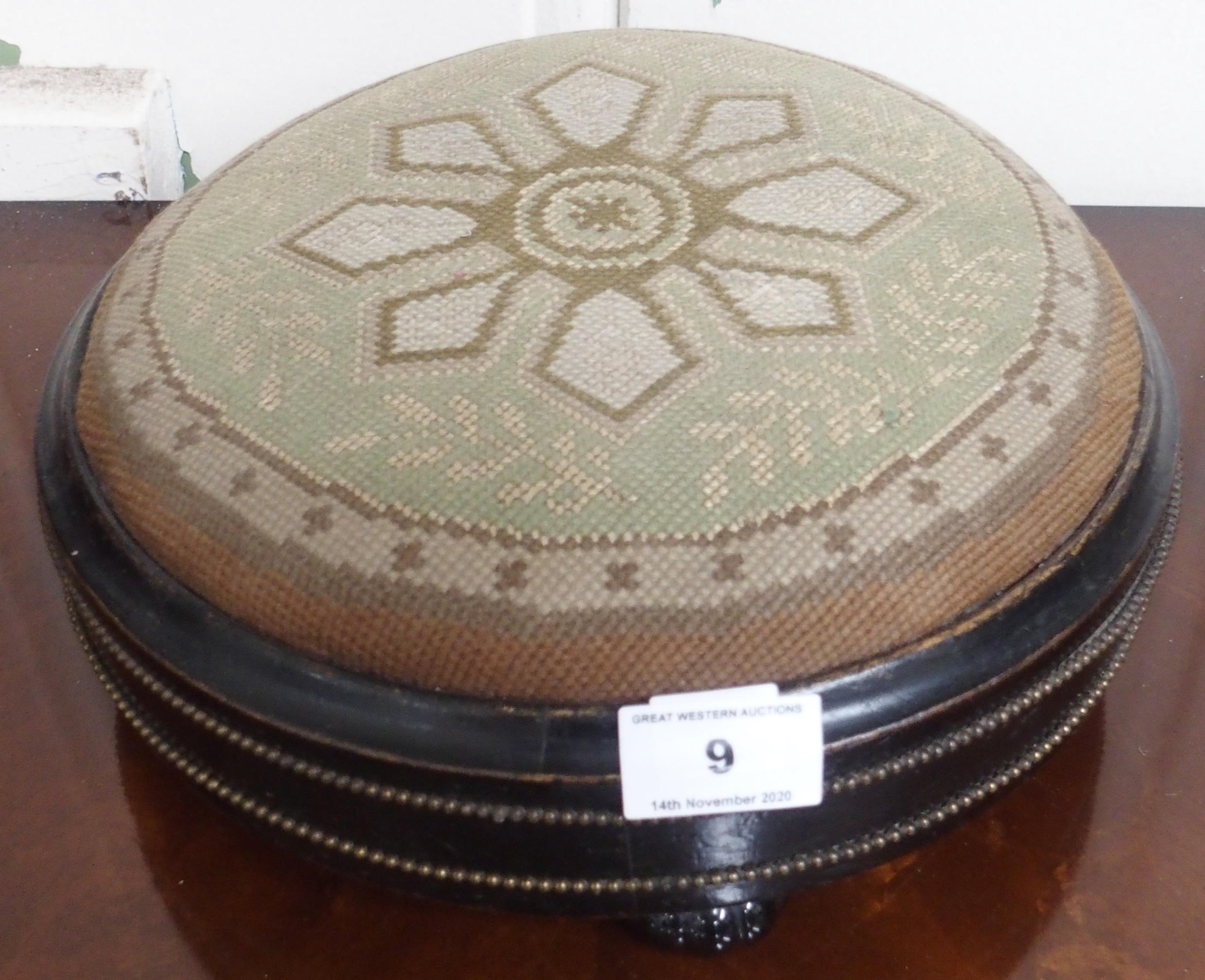 A Victorian ebonised circular footstool Condition Report: Available upon request