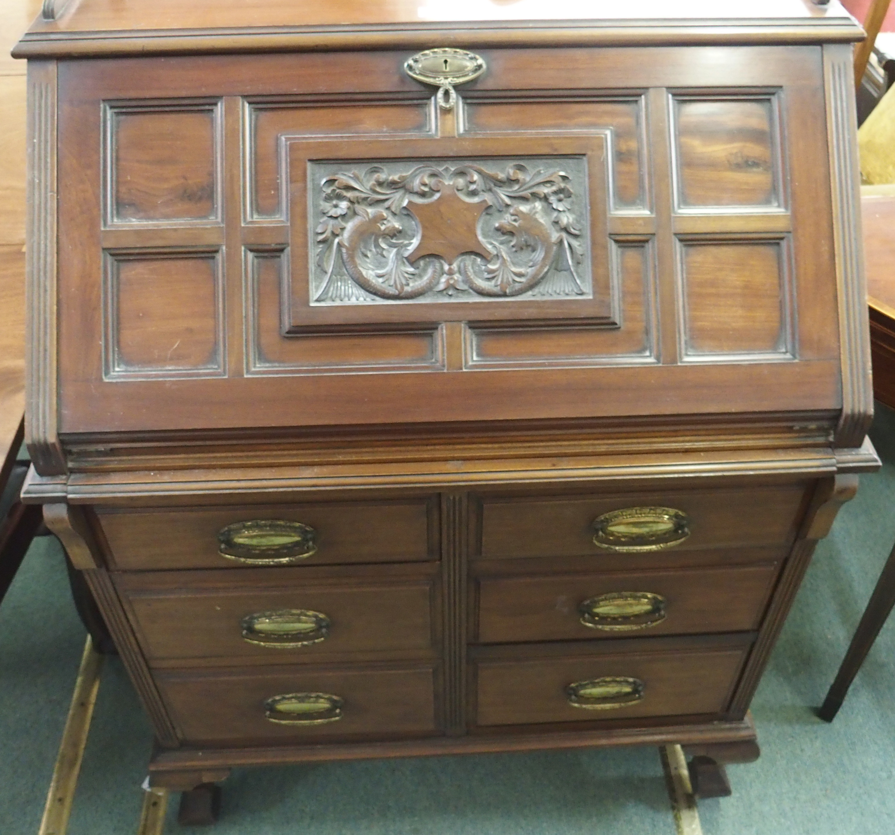 A mahogany bureau with carved lid and six drawers, 114cm high x 80cm wide Condition Report: