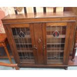 An oak bookcase with leaded and stained glass doors, 108cm high x 106cm wide Condition Report: