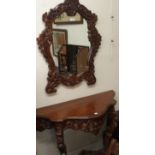 A modern carved console table, 78cm high x 106cm wide x 40cm deep and wall mirror, 90cm high x