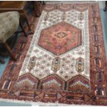 A cream ground rug with terracotta central lozenge, 207cm x 137cm Condition Report: Available upon