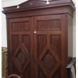 A Victorian mahogany two door wardrobe with carved doors, 228cm high x 155cm wide Condition