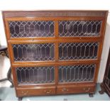 A mahogany three section leaded glass stacking bookcase with two lower drawers, 138cm high x 128cm