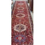 A red ground Karejeh runner, 447cm x 107cm Condition Report: Available upon request