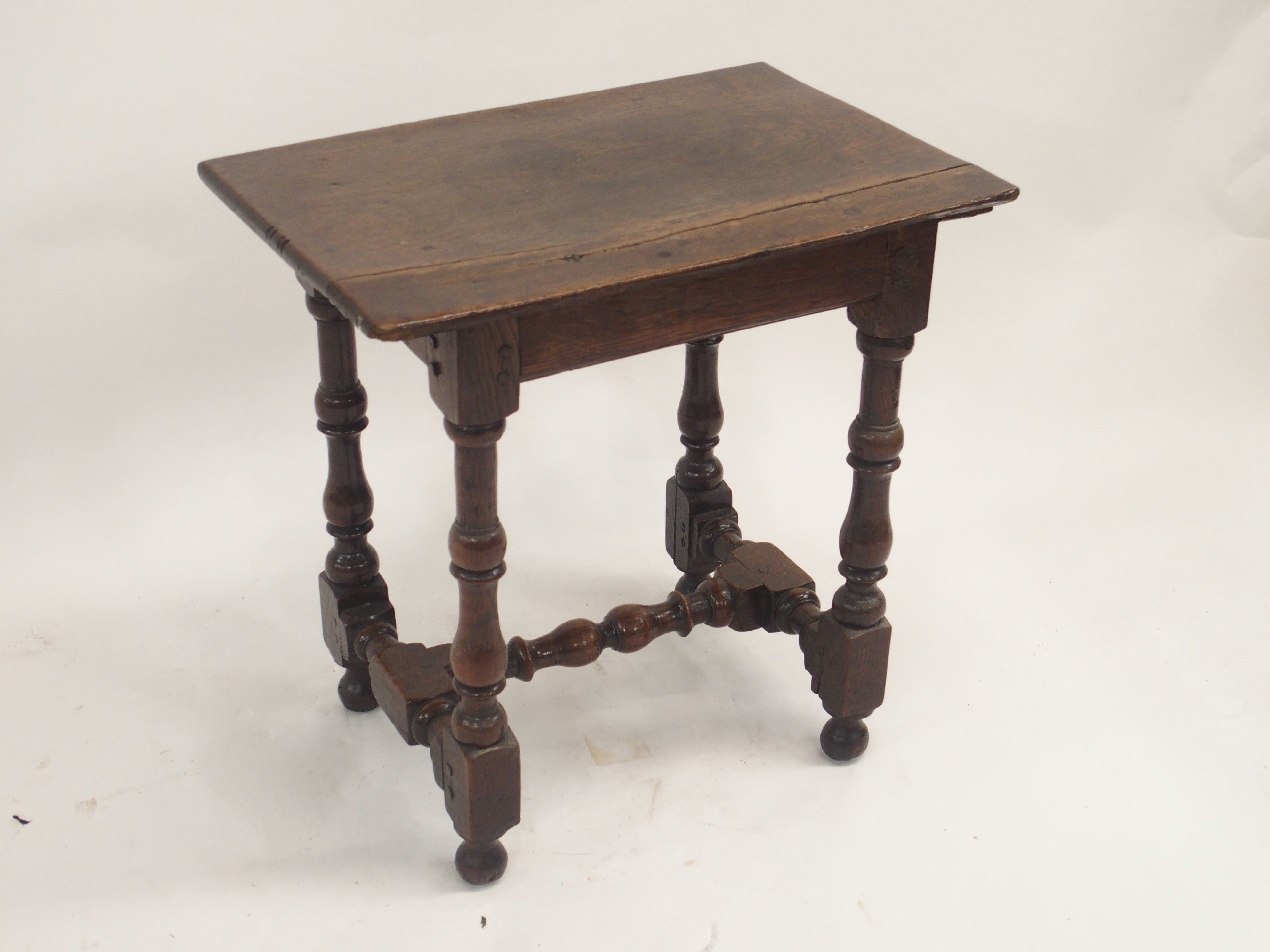 AN 18TH CENTURY AND LATER OAK JOINT STOOL the broad seat on ring turned baluster legs, joined by