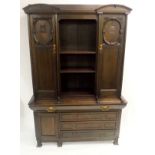 A JAMES SALMON JNR (1873-1924)BY GUTHRIE AND WELLS GREEN STAINED CYPRUS BOOKCASE with a pair of