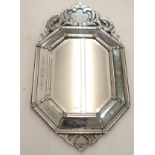 A VENETIAN CUSHION SHAPED WALL MIRROR with etched and pierced scroll surmount above an octagonal