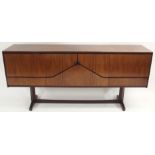 A MCINTOSH OF KIRKCALDY ROSEWOOD SIDEBOARD with envelope cabinet doors flanked by two cupboard doors