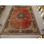 A RED GROUND KESHAN RUG WITH BLUE CENTRAL MEDALLION AND MATCHING BORDER 465cm x 313cm Condition