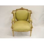 A LOUIS XV STYLE GILTWOOD ARMCHAIR the frame carved with laurel wreath, acanthus and stiff leaves,