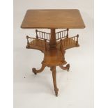 A VICTORIAN SATIN BIRCH REVOLVING BOOKSTAND the rectangular top above three divisions, joined by a