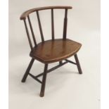 A PRIMITIVE ELM STICK CHAIR the curved rail back above five spars, joined to a shaped seat and on