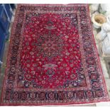 A RED GROUND KESHAN RUG, with blue central medallion and border, 378cm x 292cm Condition Report: