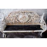 A VICTORIAN CAST IRON GARDEN BENCH decorated with a carouche with a classical woman holding a dove