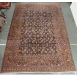 A BLUE GROUND EASTERN RUG WITH ALLOVER FLORAL DESIGN with multiple borders, 312cm x 218cm