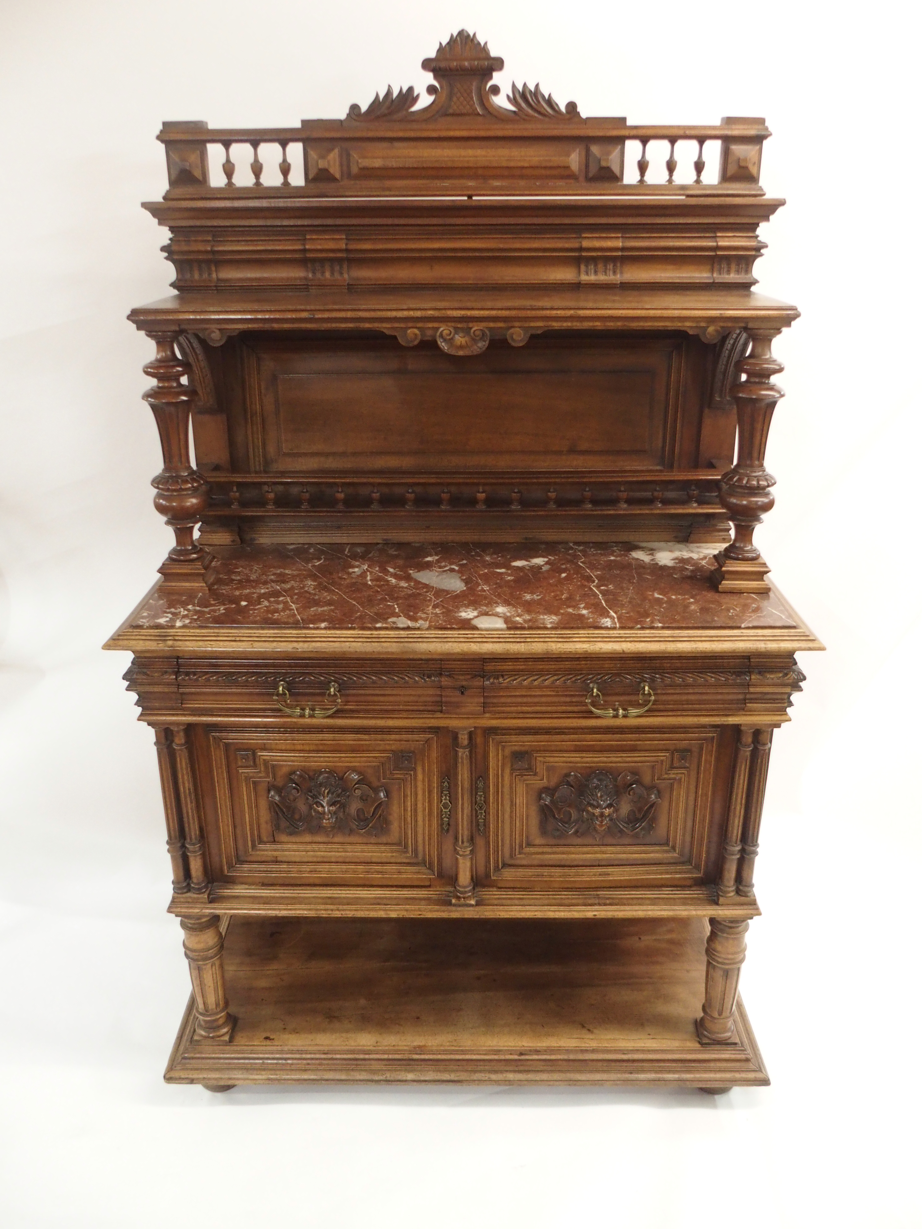 A CONTINENTAL WALNUT SIDEBOARD the back with broad shelf on fluted supports,above a gallery and