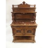 A CONTINENTAL WALNUT SIDEBOARD the back with broad shelf on fluted supports,above a gallery and