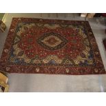 A RED GROUND VINTAGE PERSIAN TABRIZ RUG WITH BLUE CENTRAL MEDALLION, 380cm x 275cm