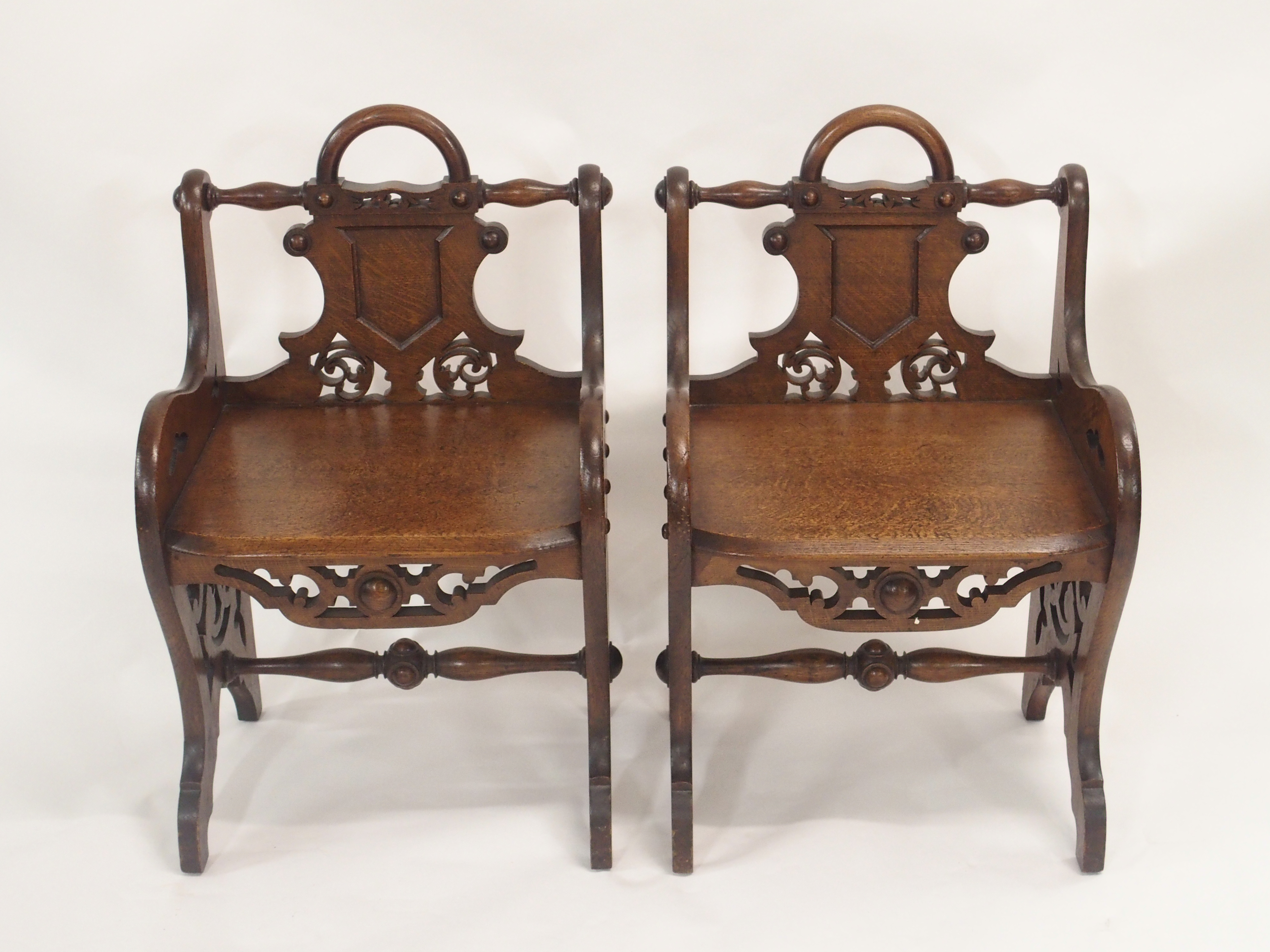 A PAIR OF VICTORIAN OAK HALL CHAIRS each carved with a shield back and pierced scrolls with loop - Image 2 of 12