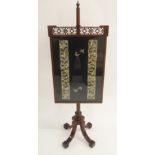 AN EDWARDIAN MAHOGANY POLESCREEN the fretwork frame inset with Chinese silk sleeve panels and on a