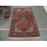 A PINK GROUND SAROUGH RUG, with central medallion and matching border, 213cm x 130cm Condition