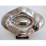 AN ARTS AND CRAFTS HAMMERED SILVER DISH by Gilbert Marks, London 1906, navette shaped, finely chased