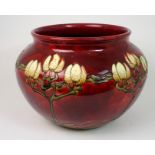 A MINTON SECESSIONIST JARDINIERE the burgundy ground with tube lined stylised flower decoration,