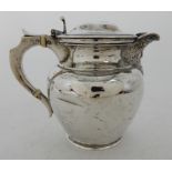 AN EDWARDIAN SILVER LIDDED ALE JUG by Davidson, Henderson and Sorley, Glasgow 1908, the hinged lid