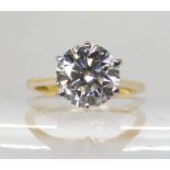 AN 18CT YELLOW AND WHITE GOLD DIAMOND SOLITAIRE the brilliant cut diamond of estimated approx
