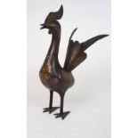 A PERSIAN DAMASCENED GILT AND STEEL BIRD standing upright with tail feathers aloft, 34cm high