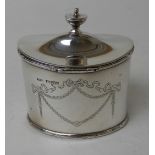 A SILVER TEA CADDY by Stokes & Ireland Limited, Chester 1911, of oval form with hinged cover and