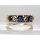 AN 18CT FRENCH GOLD BLUE GEM AND DIAMOND RING in scrolled setting, stamped with the French eagles