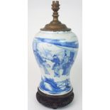 A CHINESE BLUE AND WHITE BALUSTER VASE painted with a mandarin and courtesans in a pavilion within a