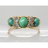 AN 18CT GOLD TURQUOISE AND DIAMOND RING in a traditional scrolled mount, size N, 3.9gms Condition