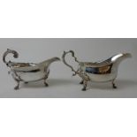 A SILVER SAUCEBOAT by Thomas Bradbury & Sons, London 1905, with scrolling handle on three pad feet