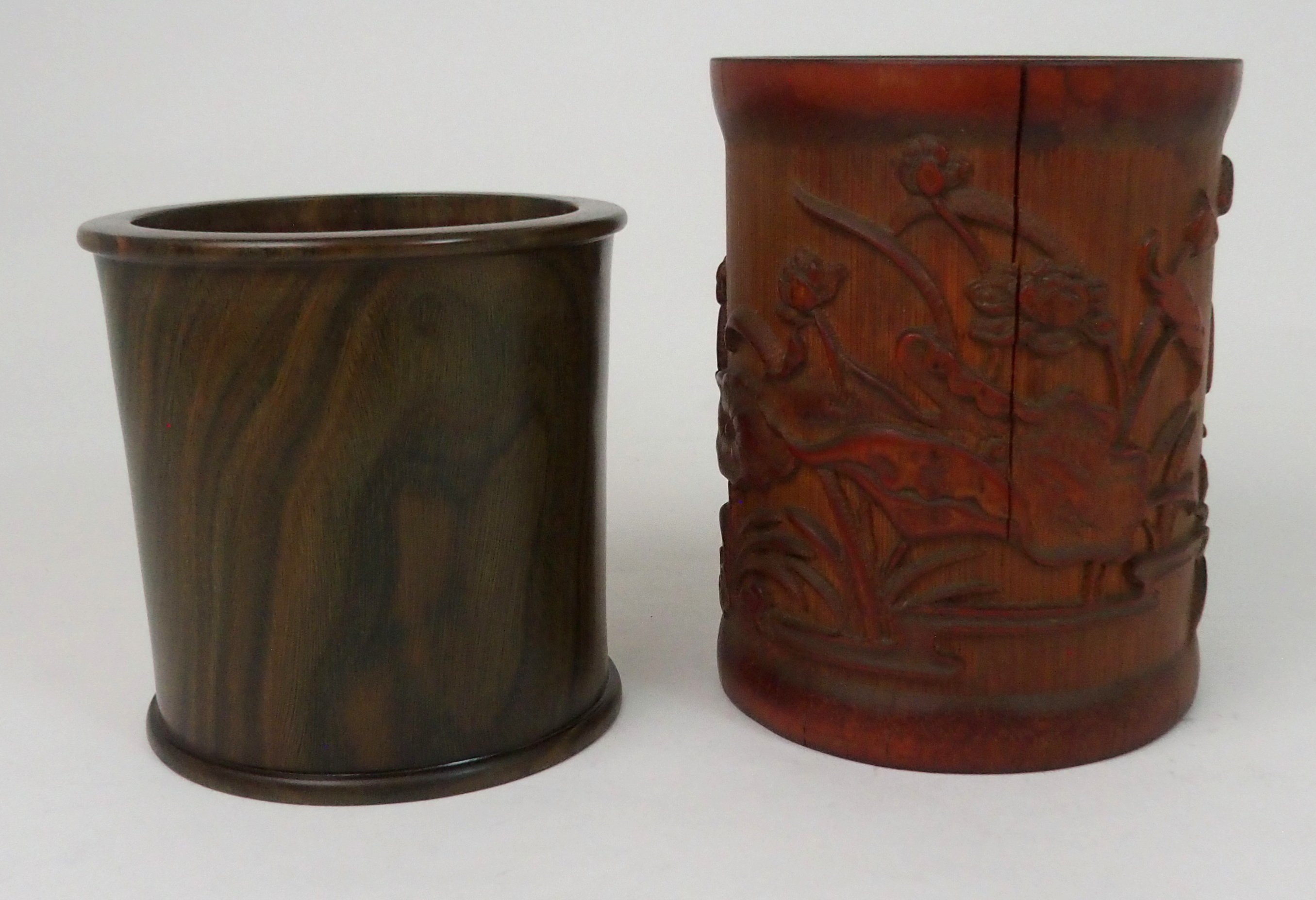 A CHINESE BAMBOO BRUSHPOT carved with lilies and foliage, 15.5cm high and a hardwood brushpot,