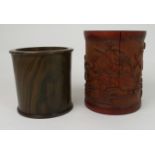 A CHINESE BAMBOO BRUSHPOT carved with lilies and foliage, 15.5cm high and a hardwood brushpot,