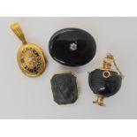 A COLLECTION OF MOURNING JEWELLERY an onyx pendant brooch, set with a old cut diamond of estimated